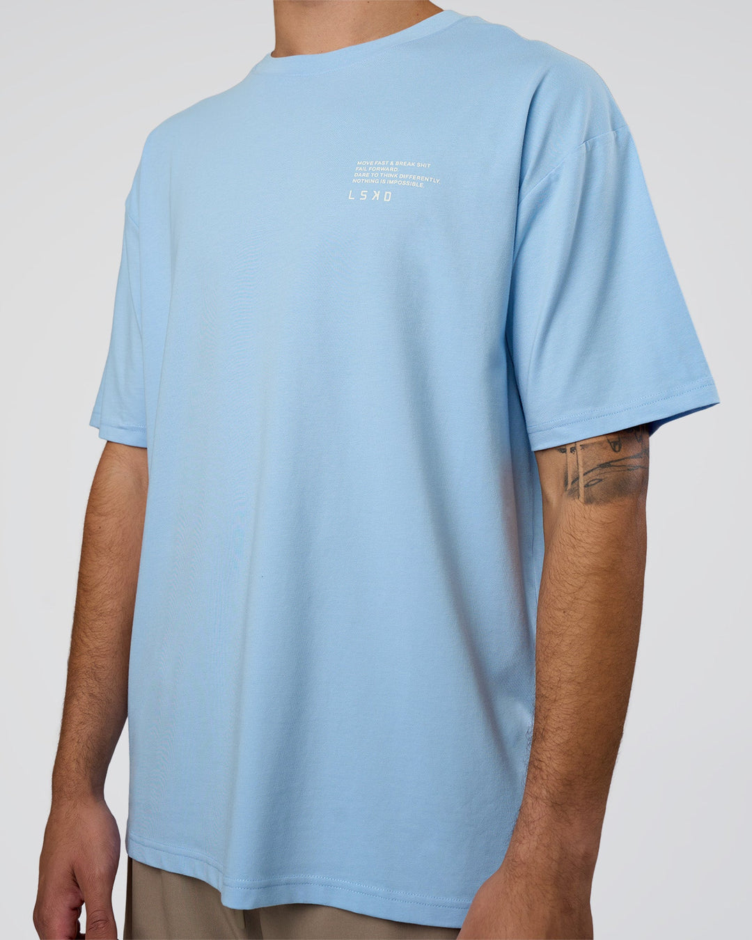 Man wearing Coffee Run FLXCotton Oversized Tee - Open Air-White | Model:Zoran | Size:M