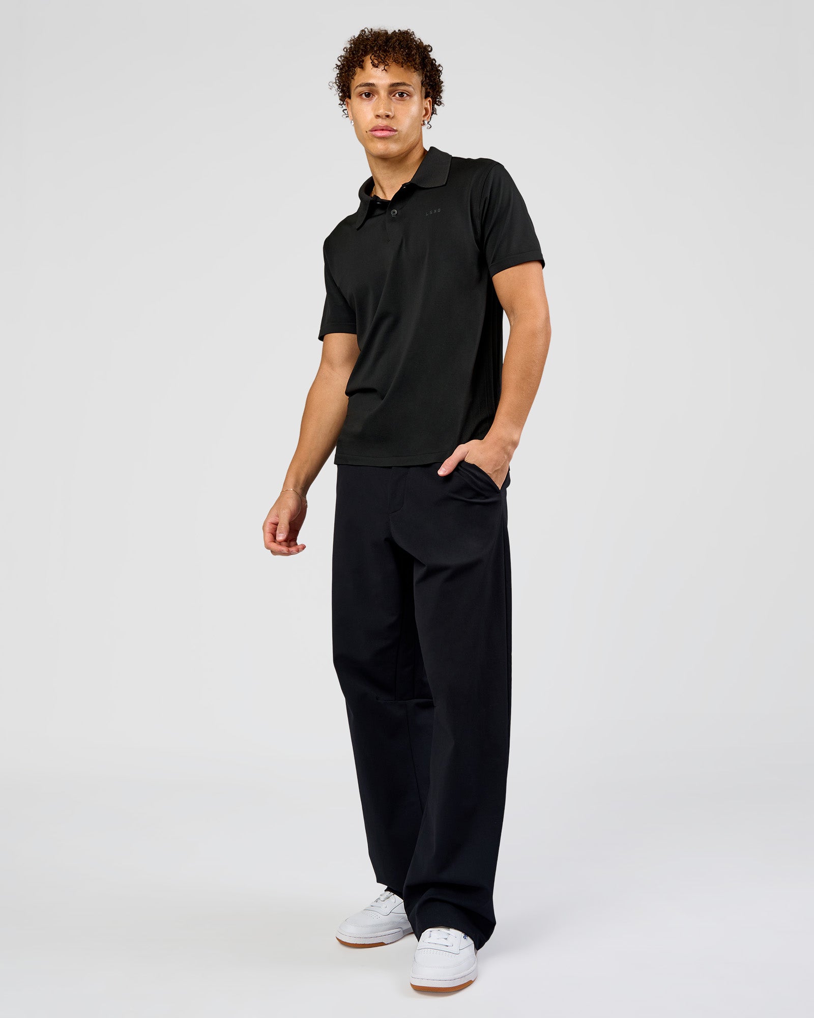 Man wearing Drive Seamless Polo - Black | Model:Leandro | Size:M
