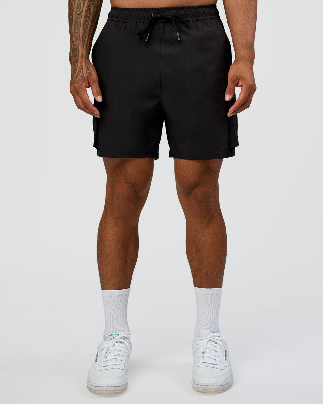 Man wearing Energy Stretch 6" Performance Cargo Short - Black | Model:Daarian | Size:M