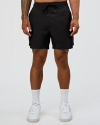 Man wearing Energy Stretch 6" Performance Cargo Short - Black | Model:Daarian | Size:M
