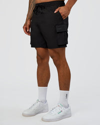 Man wearing Energy Stretch 6" Performance Cargo Short - Black | Model:Daarian | Size:M