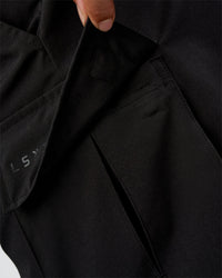 Man wearing Energy Stretch 6" Performance Cargo Short - Black | Model:Daarian | Size:M