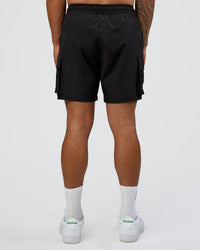 Man wearing Energy Stretch 6" Performance Cargo Short - Black | Model:Daarian | Size:M