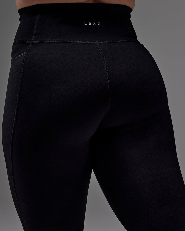 Woman wearing Fusion 3/4 Length Tight with Pockets in Black | Size:M
