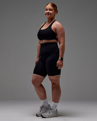 Woman wearing Fusion Ultra High-Rise 9" Short Pockets - Black | Model:Caity | Size:M