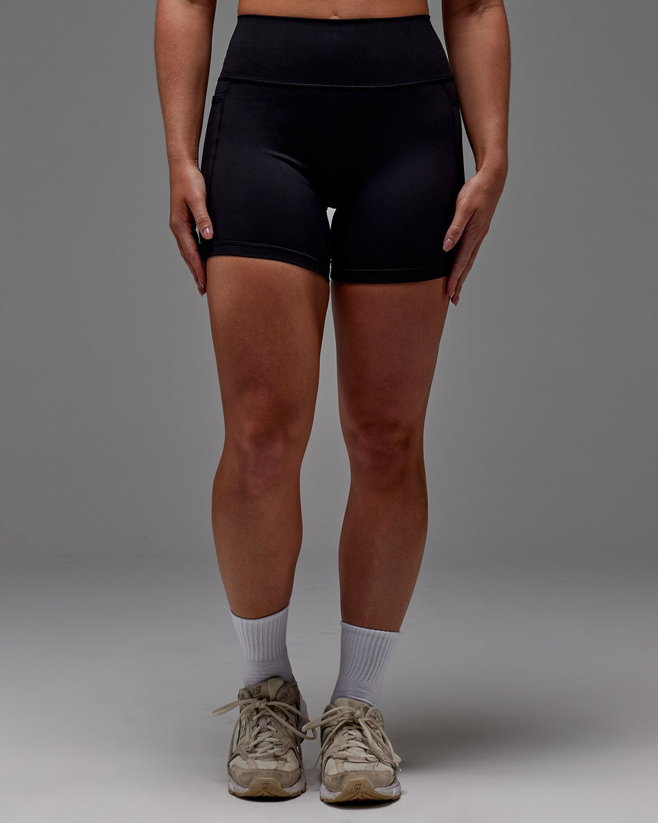 Woman wearing Fusion Mid Short Tight With Pockets in Black | Size:M