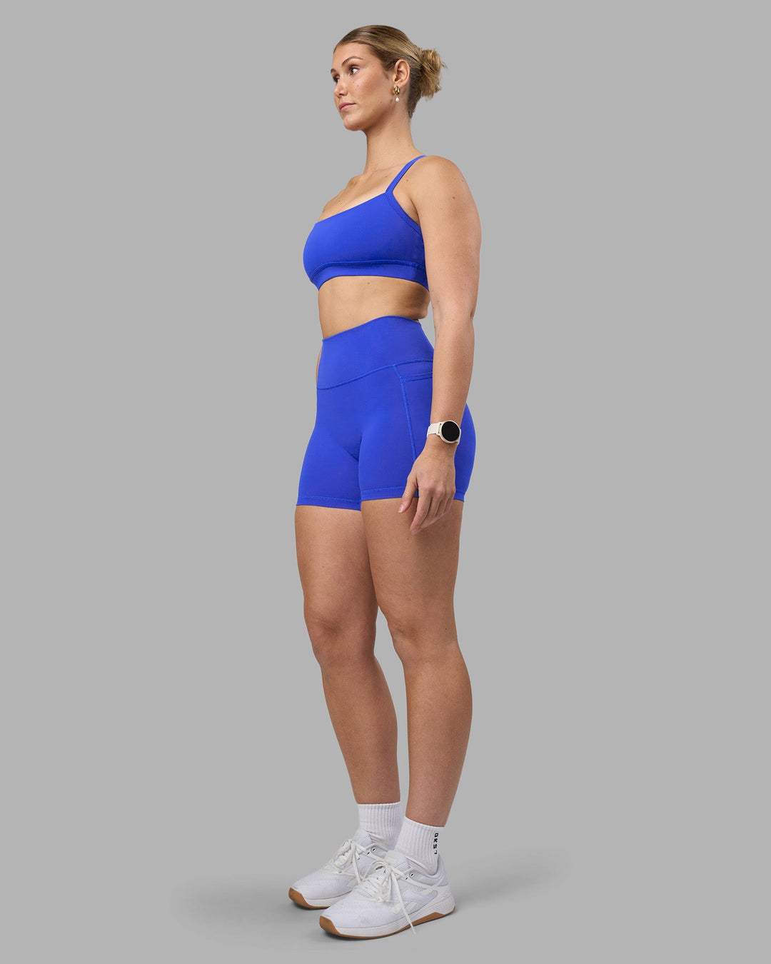Woman wearing Fusion Ultra High-Rise 4&quot; Short Pockets - Power Cobalt | Model:Amy | Size:M