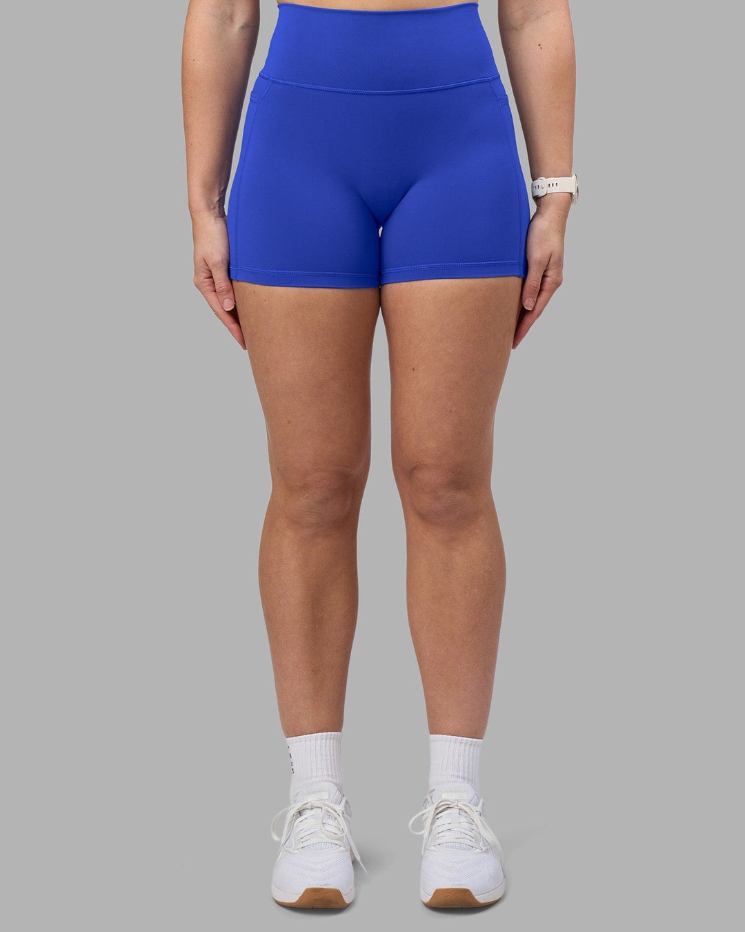 Woman wearing Fusion Ultra High-Rise 4&quot; Short Pockets - Power Cobalt | Model:Amy | Size:M