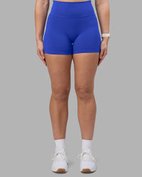 Woman wearing Fusion Ultra High-Rise 4" Short Pockets - Power Cobalt | Set:true | Angle:front | Model:Amy | Size:M