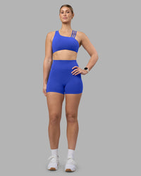 Woman wearing Fusion Ultra High-Rise 4" Short - Power Cobalt | Model:Amy | Size:M