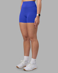 Woman wearing Fusion Ultra High-Rise 4" Short - Power Cobalt | Set:true | Angle:side | Model:Amy | Size:M