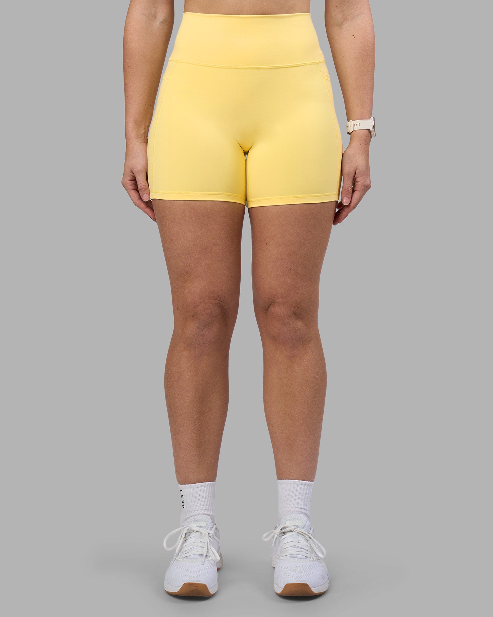 Woman wearing Fusion Ultra High-Rise 6" Short Pockets - Lemon | Model:Amy | Size:M