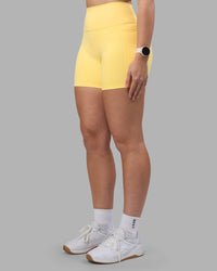 Woman wearing Fusion Ultra High-Rise 6" Short Pockets - Lemon | Set:true | Angle:side | Model:Amy | Size:M