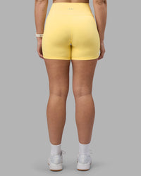 Woman wearing Fusion Ultra High-Rise 6" Short Pockets - Lemon | Set:true | Angle:back | Model:Amy | Size:M