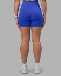 Woman wearing Fusion Ultra High-Rise 6" Short - Power Cobalt | Set:true | Angle:back | Model:Amy | Size:M