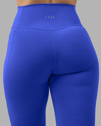 Woman wearing Fusion Ultra High-Rise 7/8 Legging Pockets - Power Cobalt | Model:Amy | Size:M