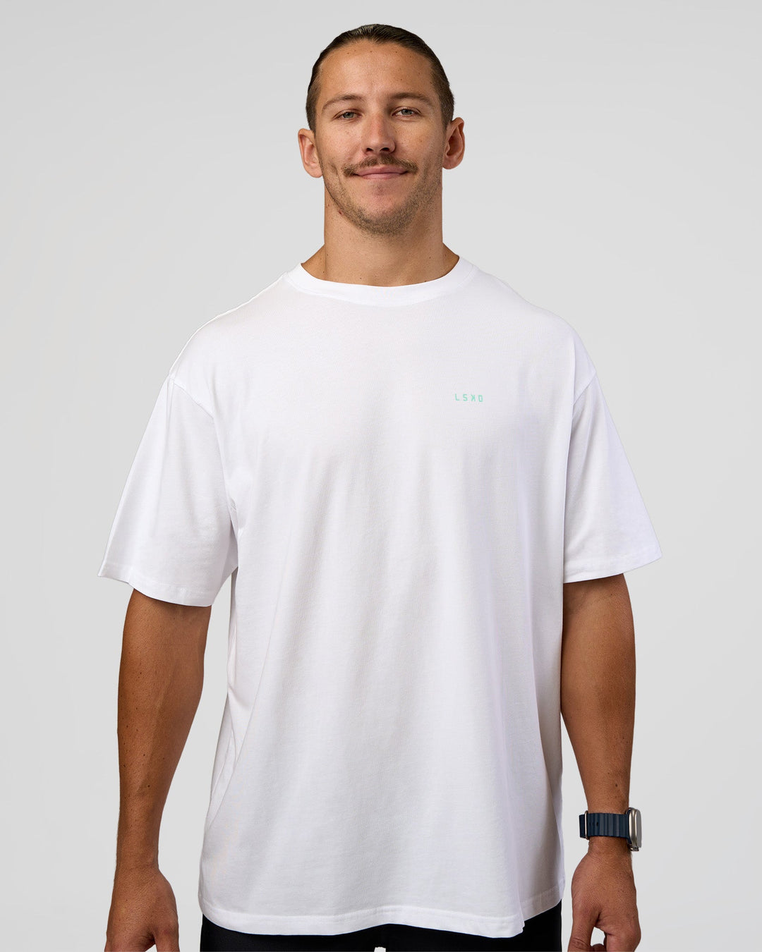 Man wearing High Run FLXCotton Oversized Tee - White-Jelly Mint | Model:Jaiden | Size:M