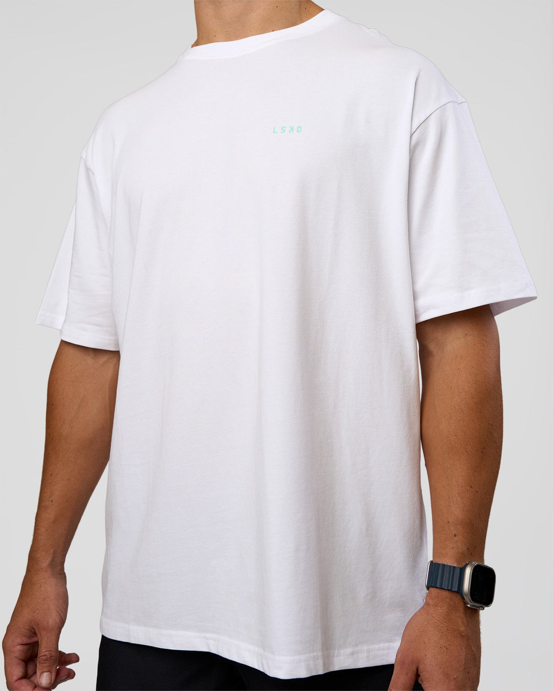Man wearing High Run FLXCotton Oversized Tee - White-Jelly Mint | Model:Jaiden | Size:M