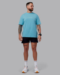 Man wearing Just Run FLXCotton Oversized Tee - Retro Blue-Light Retro Blue | Model:Macca | Size:M