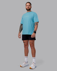 Man wearing Just Run FLXCotton Oversized Tee - Retro Blue-Light Retro Blue | Model:Macca | Size:M