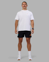 Man wearing Lift 6" Short - Black-Blue Atoll | Model:Jaiden | Size:M