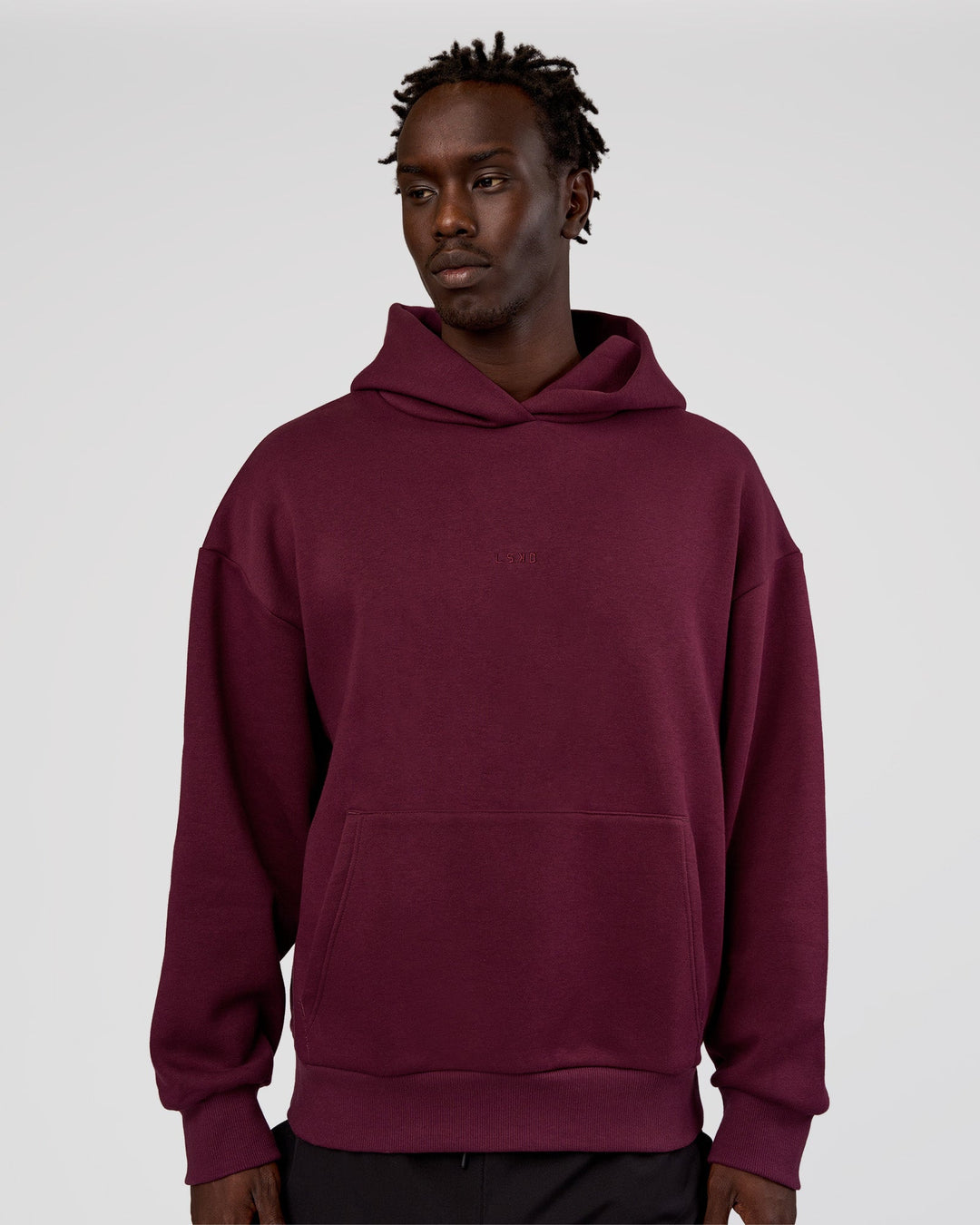 Man wearing MVP Oversized Hoodie - Cherry Lacquer | Model:Okello | Size:M