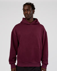 Man wearing MVP Oversized Hoodie - Cherry Lacquer | Model:Okello | Size:M