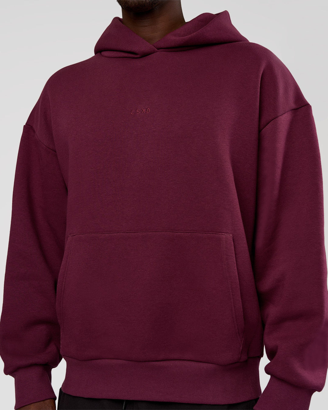 Man wearing MVP Oversized Hoodie - Cherry Lacquer | Model:Okello | Size:M