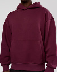 Man wearing MVP Oversized Hoodie - Cherry Lacquer | Model:Okello | Size:M