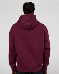 Man wearing MVP Oversized Hoodie - Cherry Lacquer | Model:Okello | Size:M