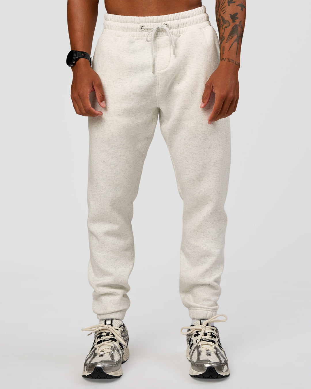 Man wearing MVP Cuffed Track Pant - Silver Marl | Model:Malebo | Size:M