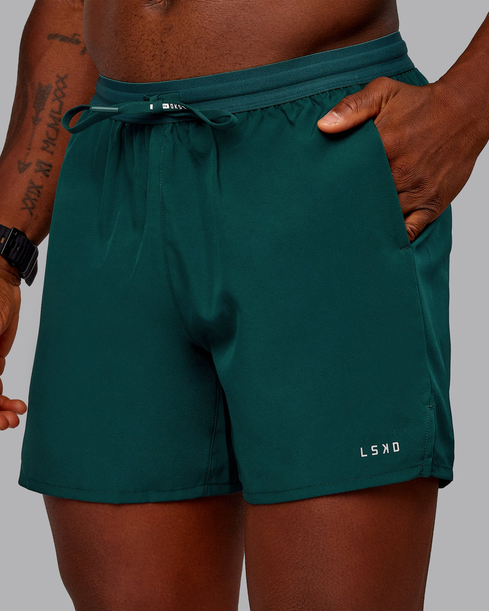 Man wearing Pace Lined Performance Short  5" in Dark Moss | Size:M