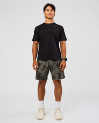 Man wearing Rep 7" Performance Short - Camo Washed Walnut Grey | Model:George | Size:M