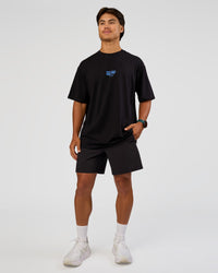 Man wearing Run Club Script FLXCotton Oversized Tee - Black-Palace Blue | Model:George | Size:M