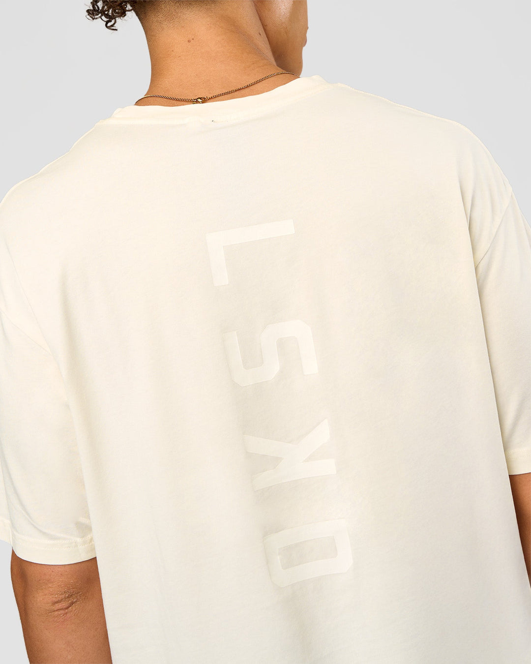 Man wearing Shadow Mode FLXCotton Oversized Tee - Off White Washed | Model:Leandro | Size:M