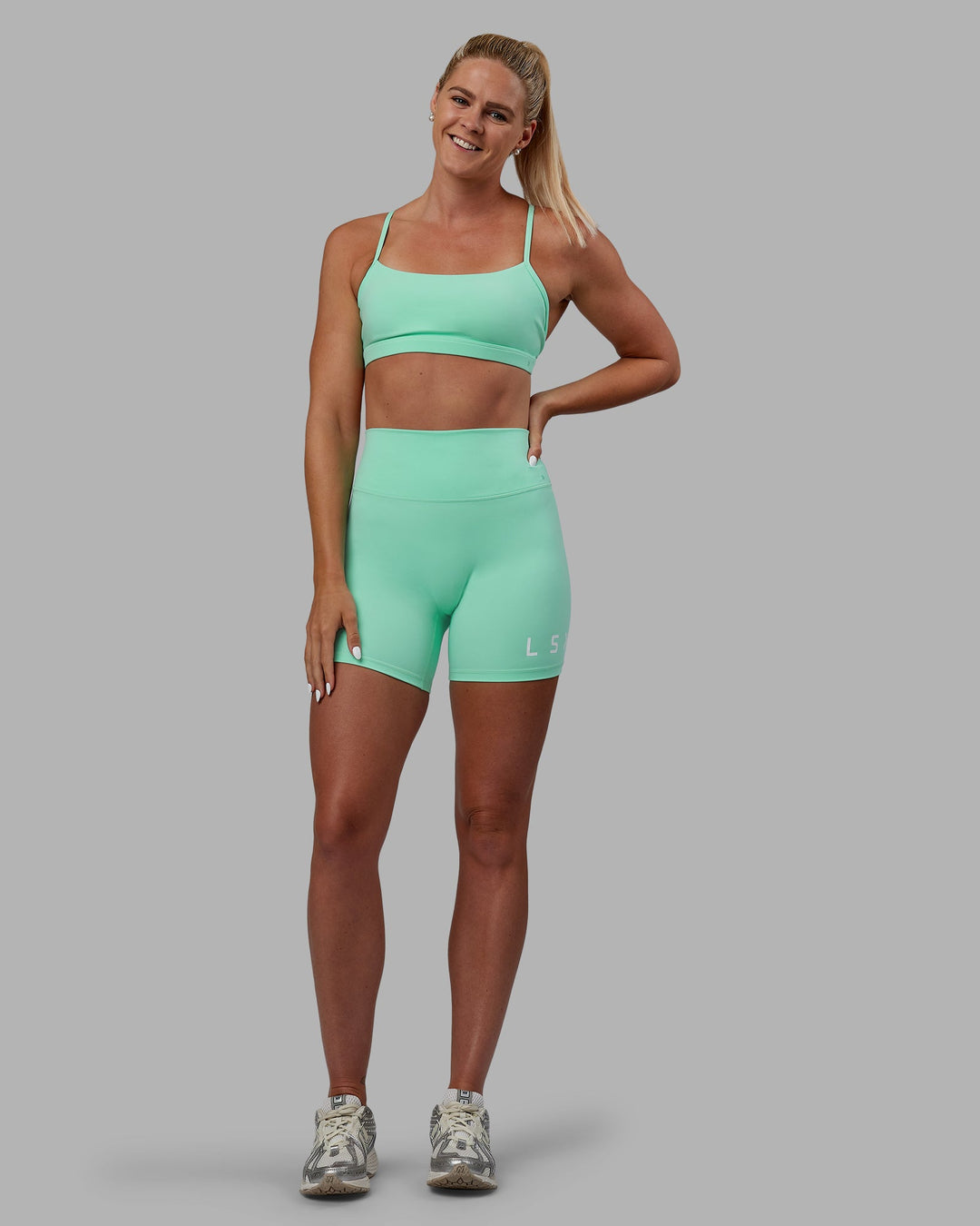 Woman wearing Shayna Jack X LSKD Evolved Mid-Length Shorts - Ice Green-White