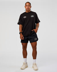 Man wearing Static Grit Heavyweight Oversized Tee - Black-Alloy | Model:Malebo | Size:M
