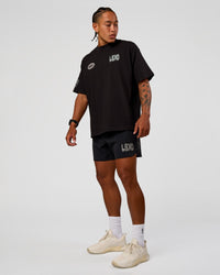 Man wearing Static Grit Heavyweight Oversized Tee - Black-Alloy | Model:Malebo | Size:M