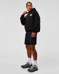 Man wearing Static Grit Unisex Boxy Hoodie - Black-Alloy | Model:Malebo | Size:M