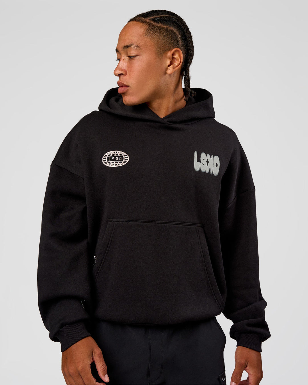 Man wearing Static Grit Unisex Boxy Hoodie - Black-Alloy | Model:Malebo | Size:M