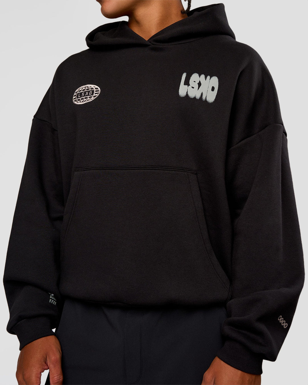 Man wearing Static Grit Unisex Boxy Hoodie - Black-Alloy | Model:Malebo | Size:M