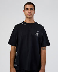 Man wearing Sticker Heavyweight Oversized Tee - Black-White | Model:Zoran | Size:M