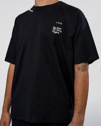 Man wearing Sticker Heavyweight Oversized Tee - Black-White | Model:Zoran | Size:M