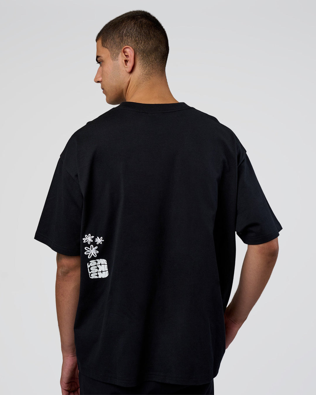 Man wearing Sticker Heavyweight Oversized Tee - Black-White | Model:Zoran | Size:M