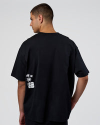 Man wearing Sticker Heavyweight Oversized Tee - Black-White | Model:Zoran | Size:M