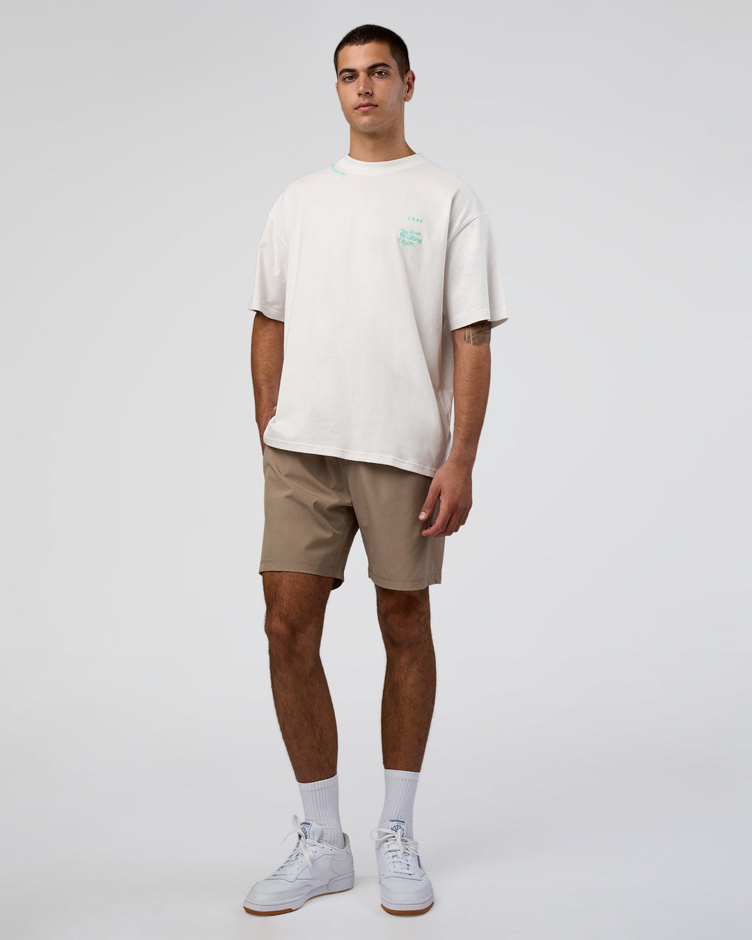 Man wearing Sticker Heavyweight Oversized Tee - Off White-Jelly Mint | Model:Zoran | Size:M