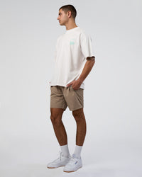 Man wearing Sticker Heavyweight Oversized Tee - Off White-Jelly Mint | Model:Zoran | Size:M