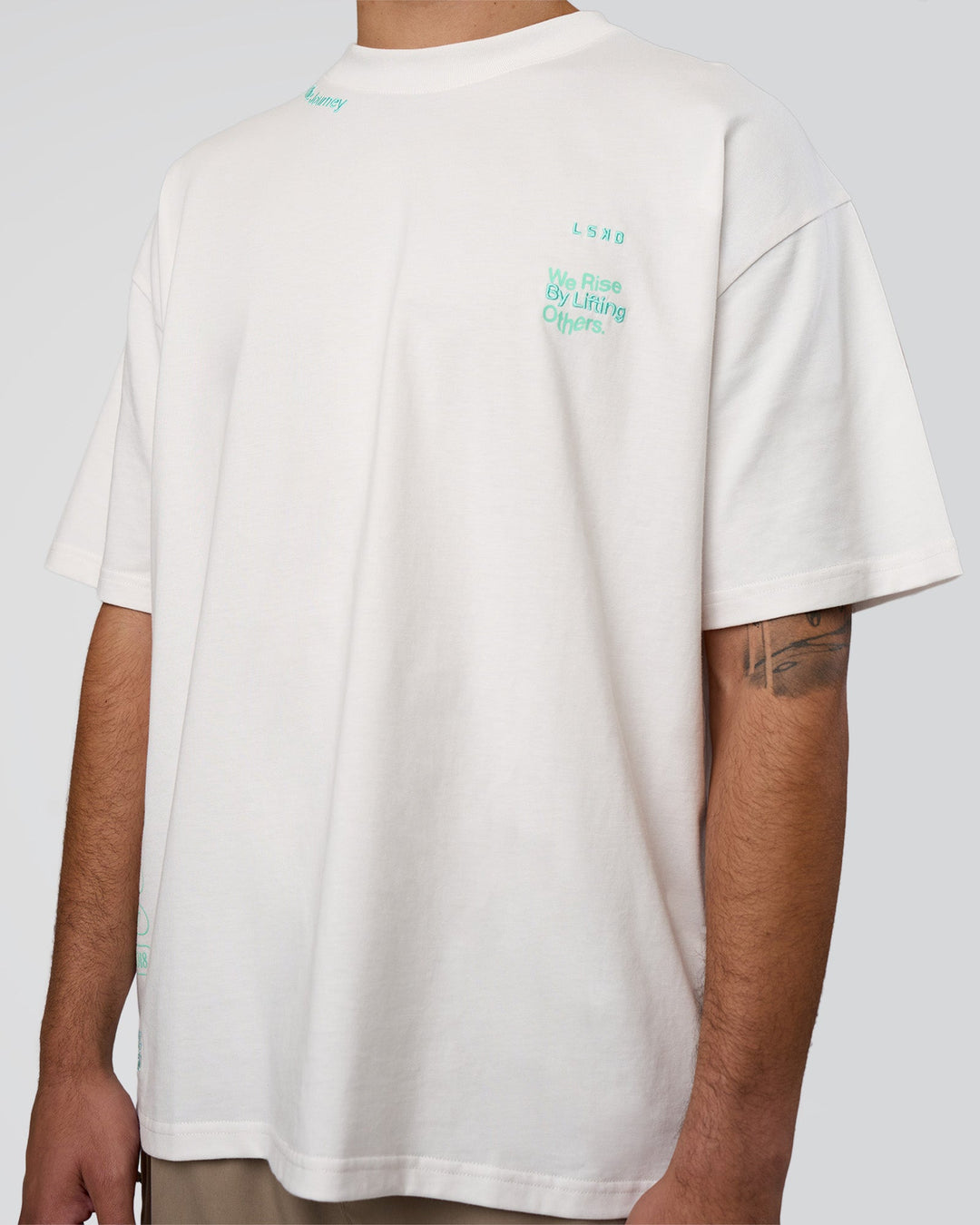 Man wearing Sticker Heavyweight Oversized Tee - Off White-Jelly Mint | Model:Zoran | Size:M