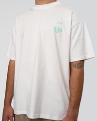 Man wearing Sticker Heavyweight Oversized Tee - Off White-Jelly Mint | Model:Zoran | Size:M