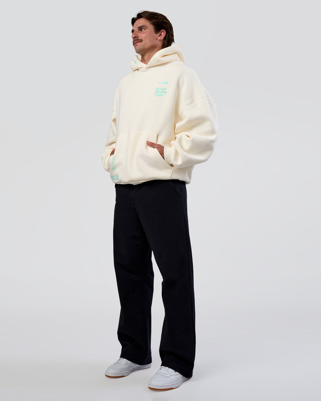Man wearing Sticker Unisex Oversized Hoodie - Off White-Jelly Mint | Model:Konnor | Size:M